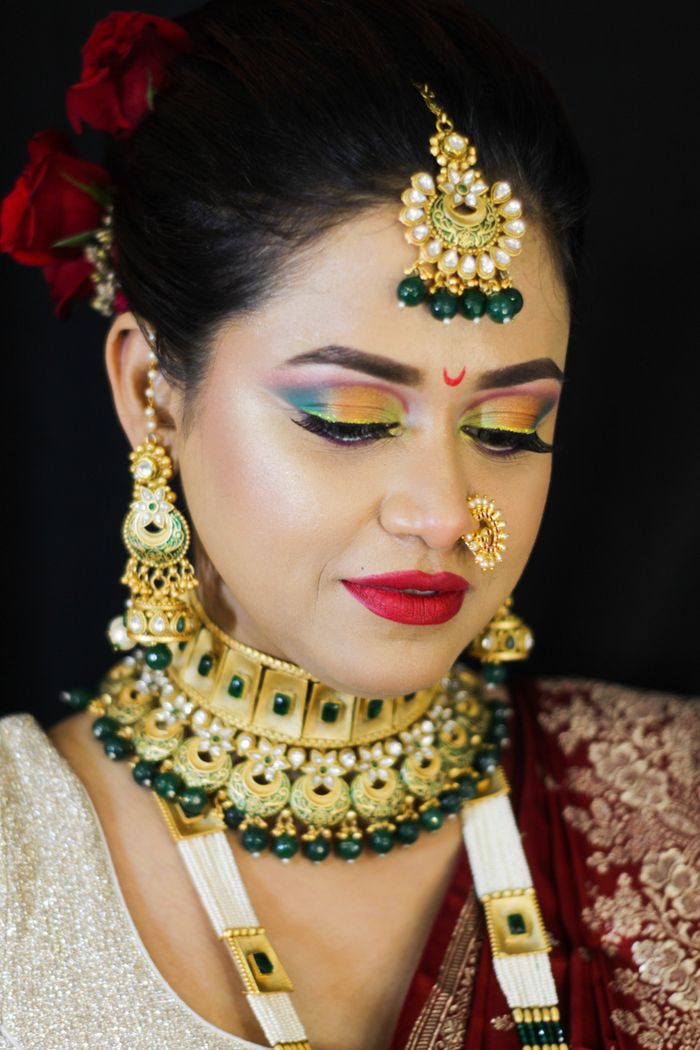 why-choose-us Beautiful Indian bride in traditional attire and ornate jewelry, featuring vibrant makeup.