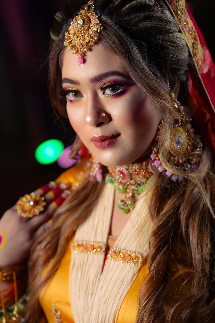 gallery-5 Close-up of a South Asian bride in ornate traditional attire with jewelry.