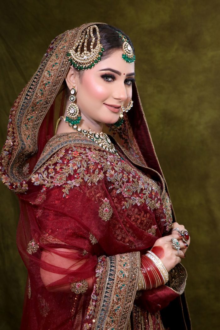 services-01 Portrait of a woman in rich traditional bridal attire with intricate jewelry.