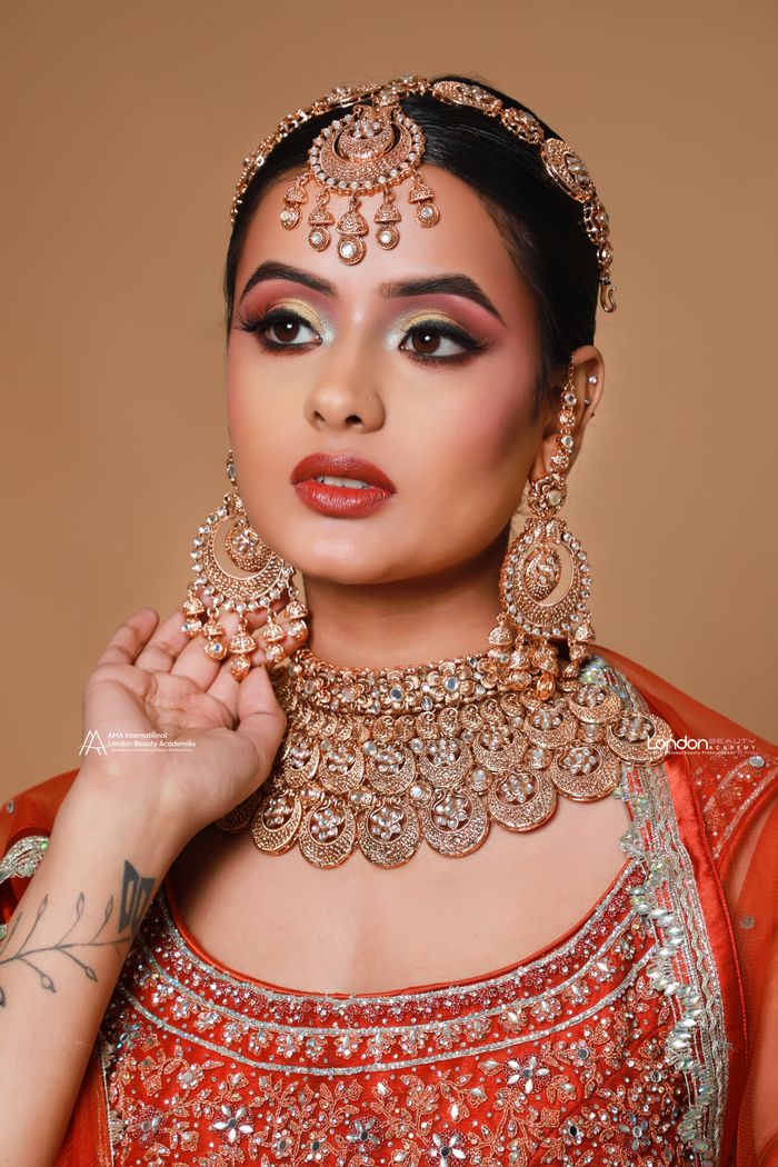 services-02 Stunning Indian bride in traditional attire with exquisite jewelry and makeup.