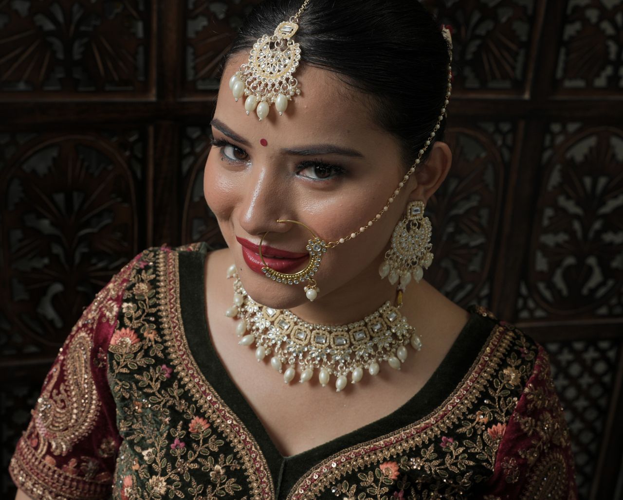 hero-img-02 A beautiful bride in intricate traditional attire and jewelry with a captivating smile.