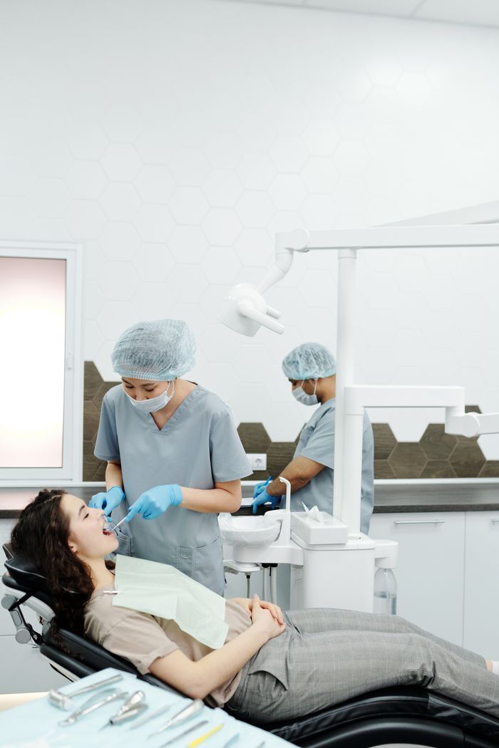 about-us A dentist performs a dental procedure on a patient in a modern clinic setting, emphasizing healthcare.