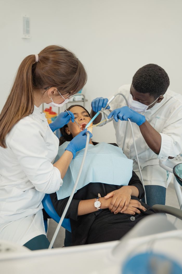 Dental professionals performing procedure on a patient in a modern clinic.