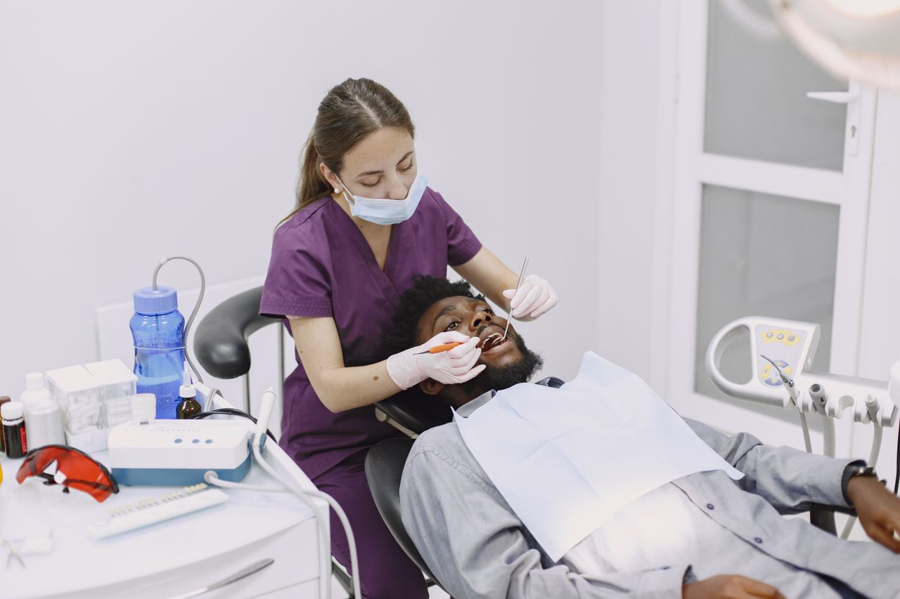 The Art of Drawing Readers In: Your attractive post title goes here A dentist conducts a dental checkup on a patient in a clinic setting.